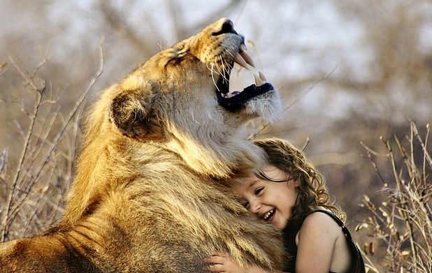 child girl hugging a lion
